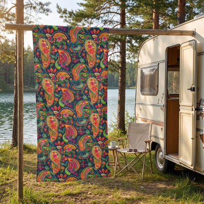 Psychedelic Paisley Party beach towel, displayed in a summer setting.