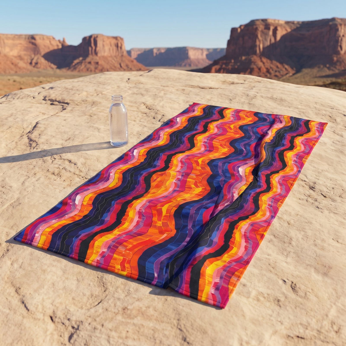 Desert Sunset Waves beach towel, displayed in a summer setting.