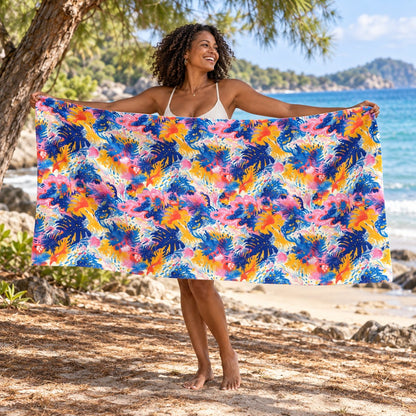 Splatter Blossom beach towel, shown with an adult in a summer setting.