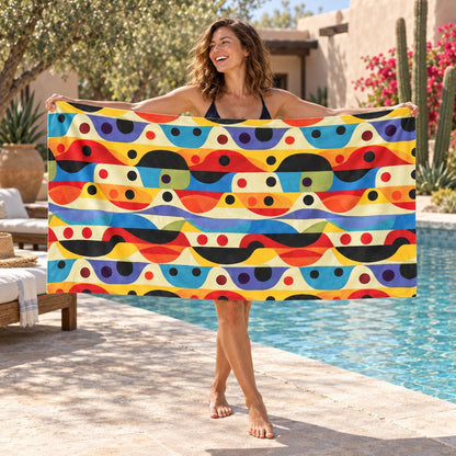 Linear Color Mesa beach towel, shown with an adult in a summer setting.
