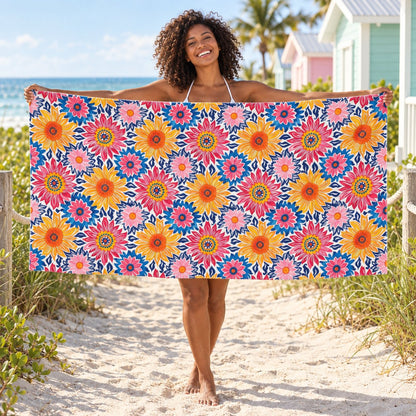 Sunsplash Petals beach towel, shown with an adult in a summer setting.