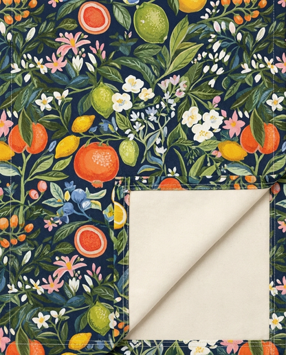 Magical Fruitiness table runner close-up — cotton twill front with natural cotton reverse and hemmed edge