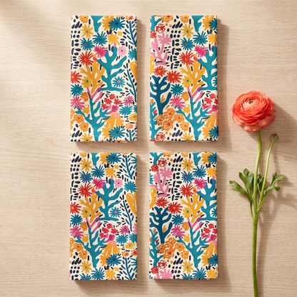 Coral Bloom Harmony dinner napkins, elongated fold, two rows of four, with a coral ranunculus
