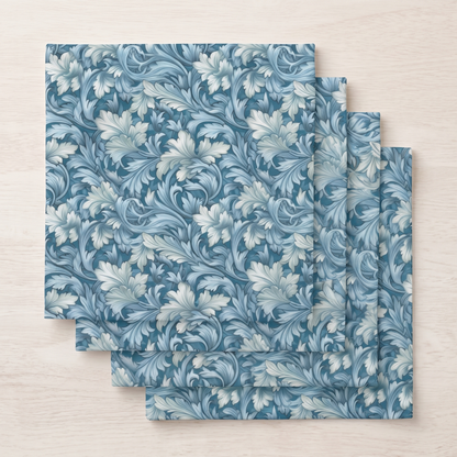 Four folded Soft Blue Leaf Tapestry dinner napkins fanned in a stack, top-down view