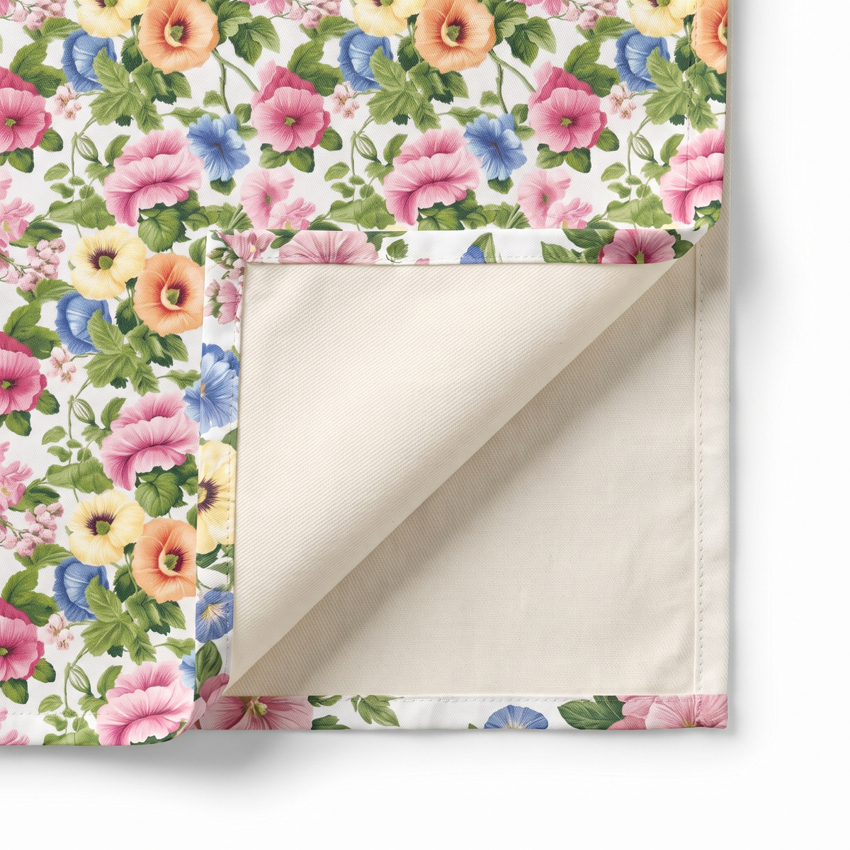 Close-up of Pastel Garden Elegance napkin corner folded back showing cream twill backside and hem