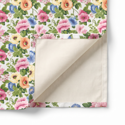Close-up of Pastel Garden Elegance napkin corner folded back showing cream twill backside and hem