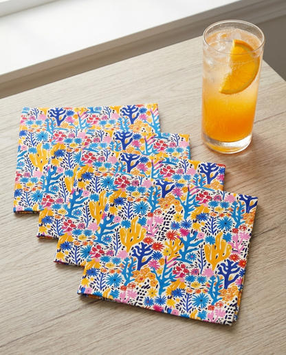 Coral Bloom Harmony cocktail napkins, set of four, with drink for scale