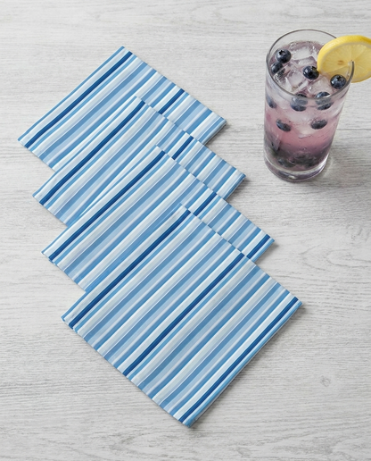 Shades of Light Blue Stripes cocktail napkins, set of four, with drink for scale