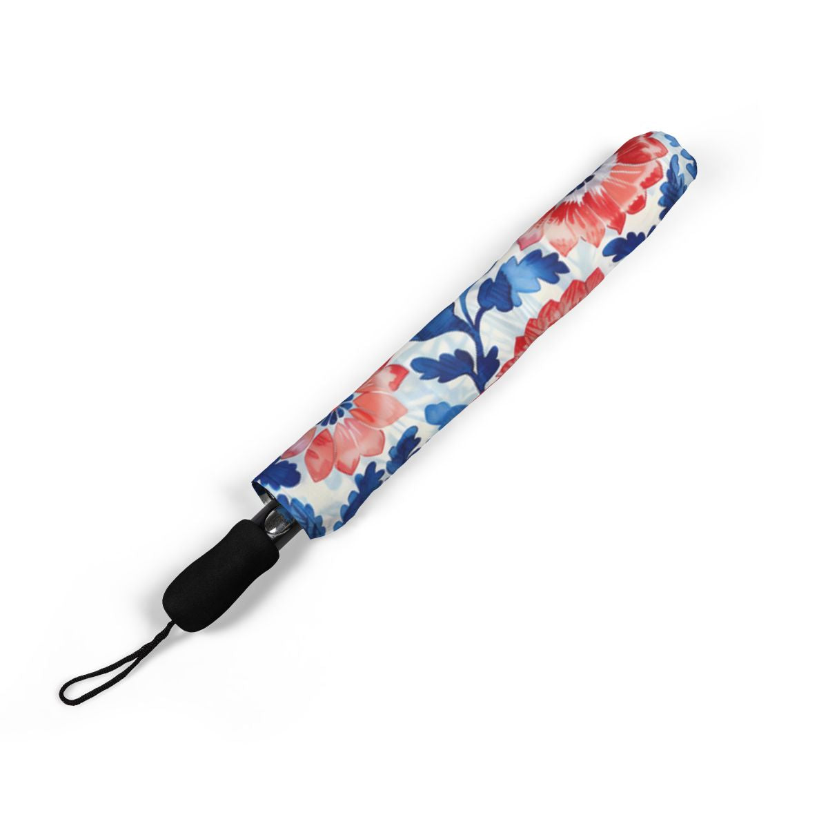 Whimsical Batik Blossoms umbrella folded closed, showing the printed canopy and wrist strap
